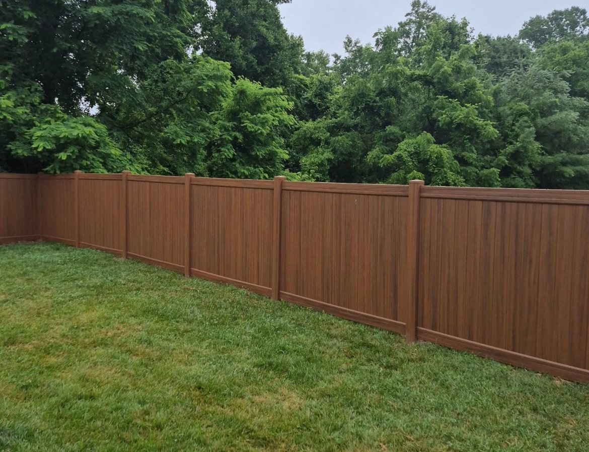 Brown vinyl privacy fence installation in Lancaster PA backyard