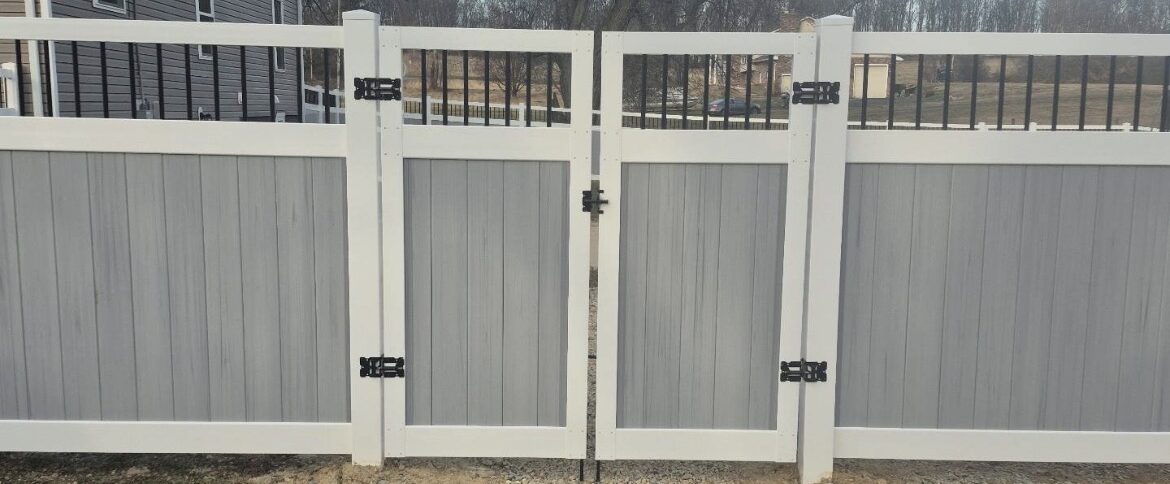 Two-tone grey and white vinyl Manhattan privacy fence with a black spindle top and a double drive gate, installed by Future Solutions Fence