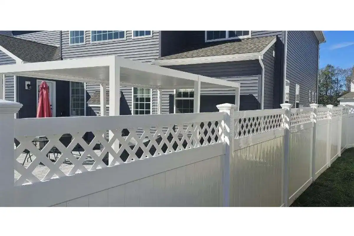 White vinyl privacy fence with a lattice top section beside a deck, installed by Future Solutions Fence