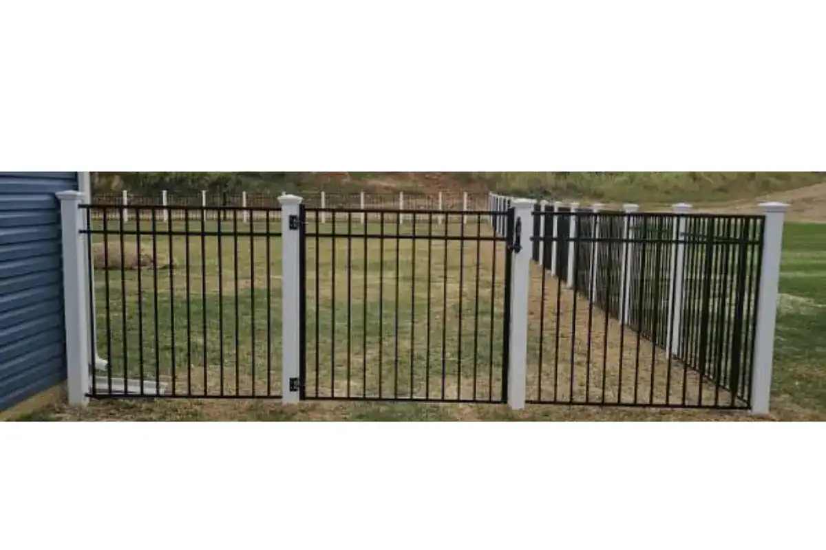 Black aluminum fence racked down a graded bank, installed by Future Solutions Fence