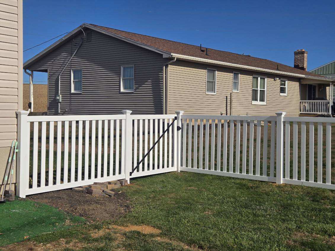 White vinyl Chestnut picket fence with a walk gate, installed by Future Solutions Fence