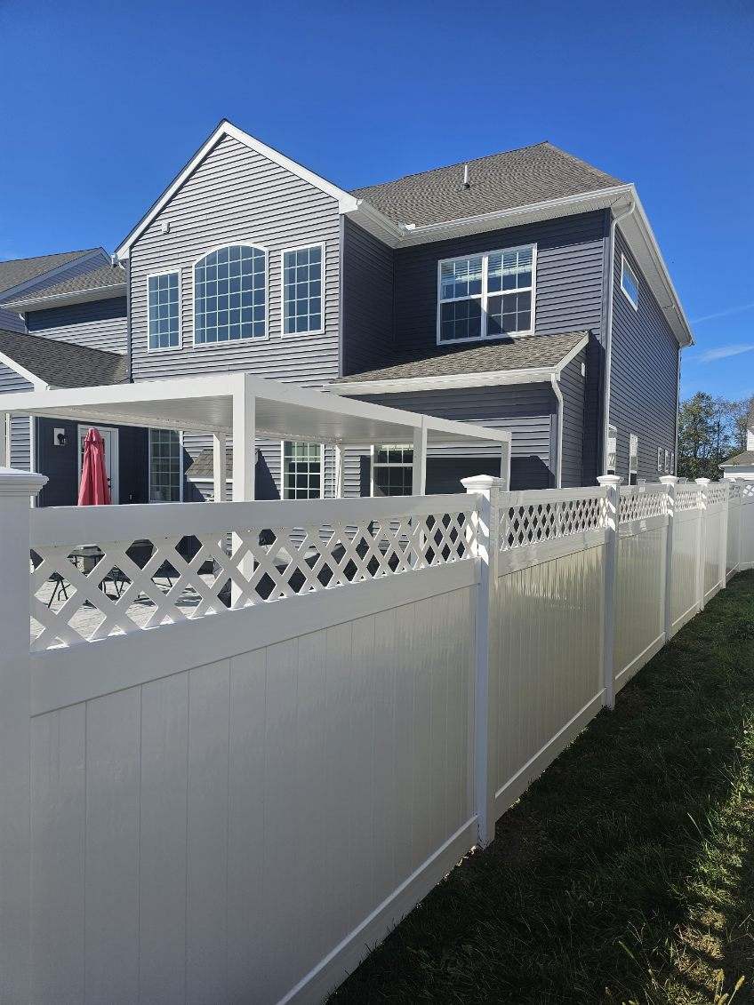White vinyl fence with a lattice top section enclosing a deck, installed by Future Solutions Fence