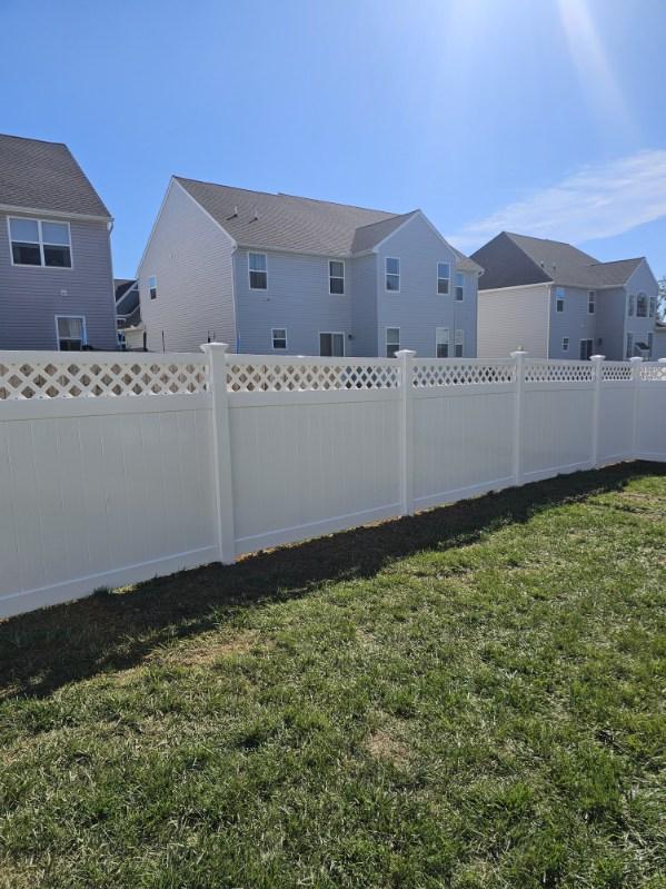 White vinyl privacy fence enclosing the rear of a newly built home, installed by Future Solutions Fence