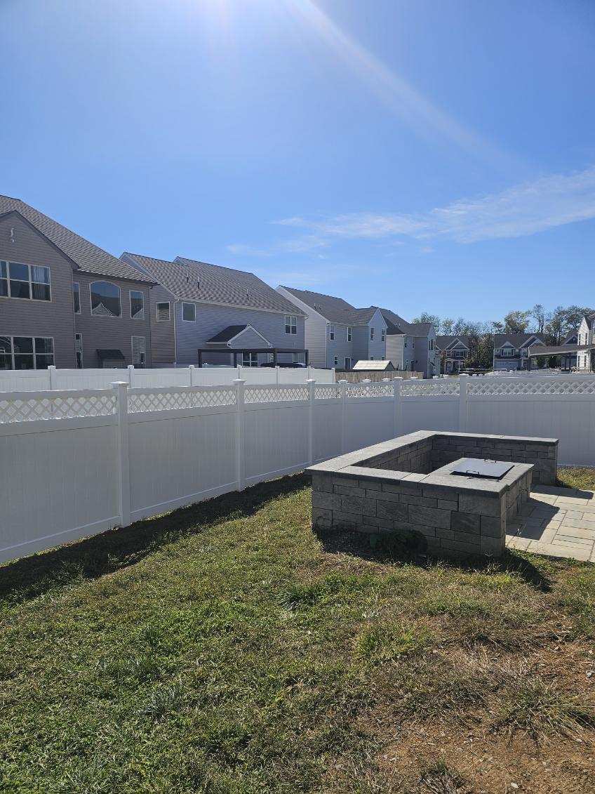 White vinyl picket fence with a lattice-top privacy return behind townhouses, installed by Future Solutions Fence