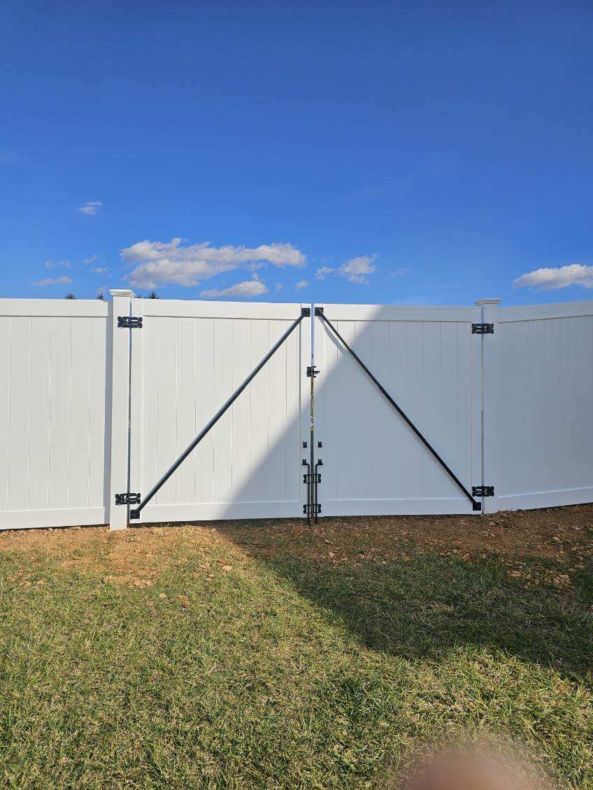White vinyl privacy fence with a lattice top section beside a house, installed by Future Solutions Fence