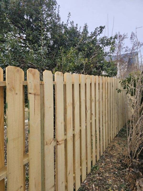 Dog-ear wood privacy fence enclosing a back yard, installed by Future Solutions Fence