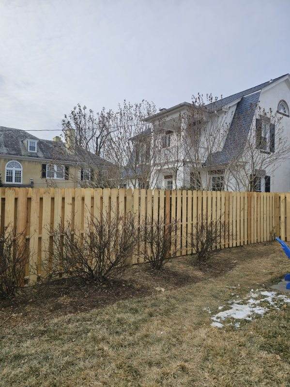 Dog-ear wood fence with a walk gate at the side of a house, installed by Future Solutions Fence