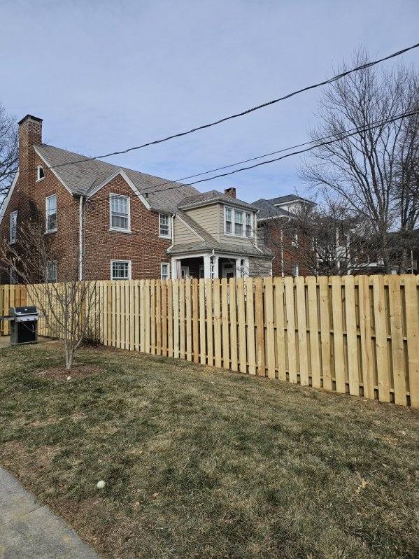 Wood stockade fence running along a street boundary, installed by Future Solutions Fence