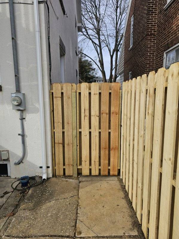 Wood privacy fence running along a side property boundary, installed by Future Solutions Fence